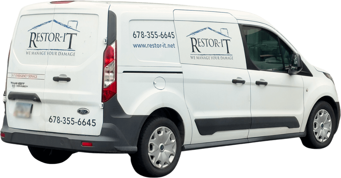 White van with "Restor-It" logo and contact information, including phone number and website URL, on the side and rear. The slogan reads, "We Manage Your Damage." Our services are designed to restore your property efficiently and effectively.